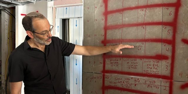 The CEO of the Bat Yam Municipality in a damaged building.